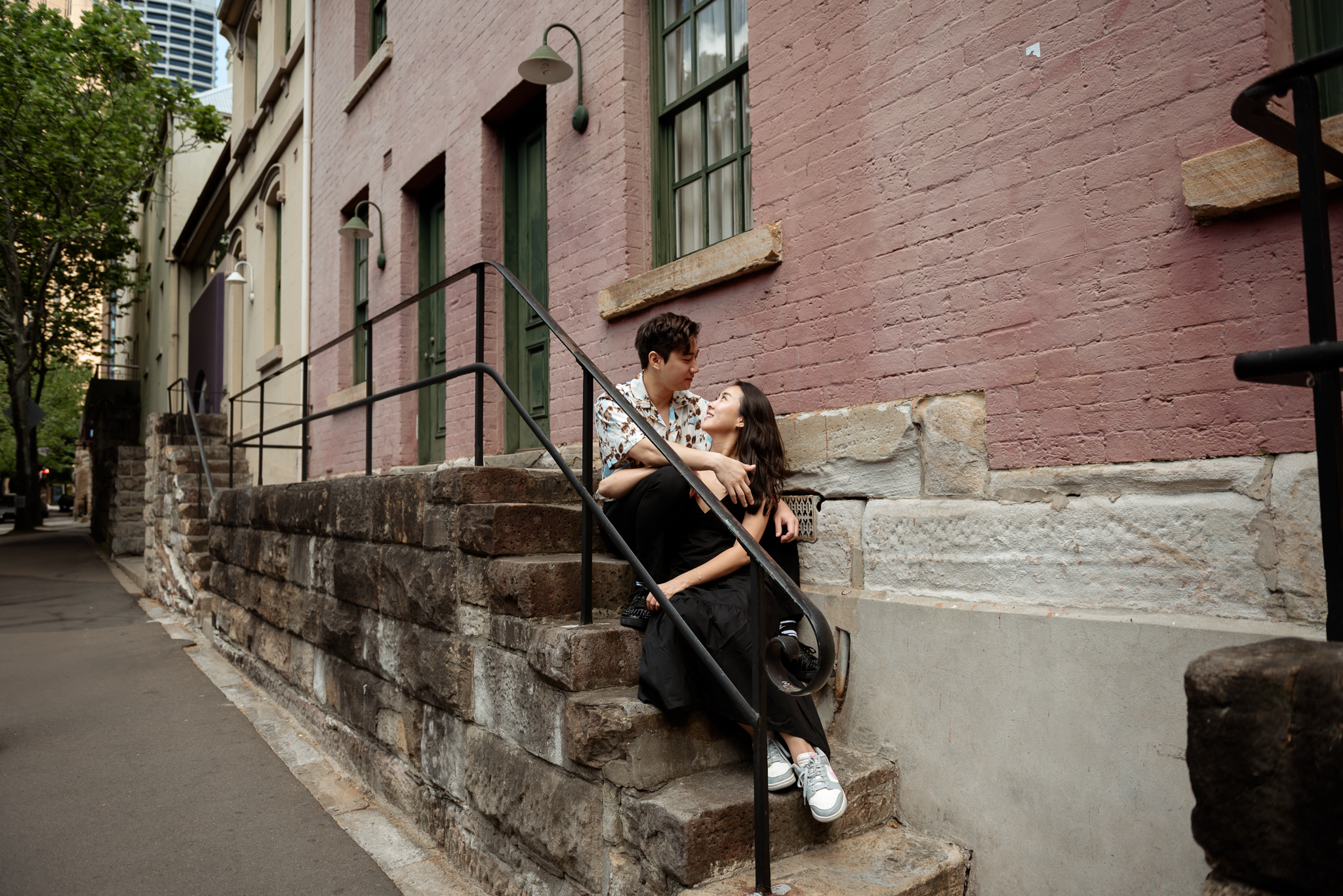 Couple visiting from Singapore in one of the most iconic walls at the Rocks in Sydney