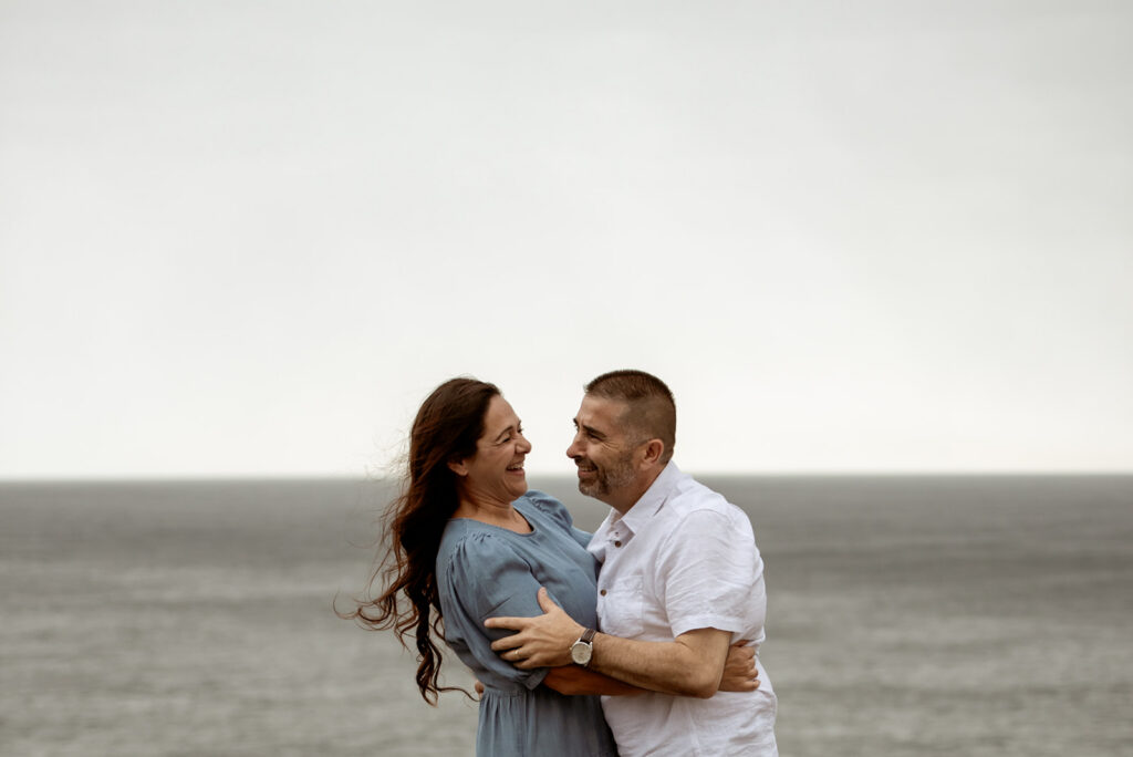 Couple laughing together during relaxed couples photography session South Coast NSW, Carolina Morgan Photography