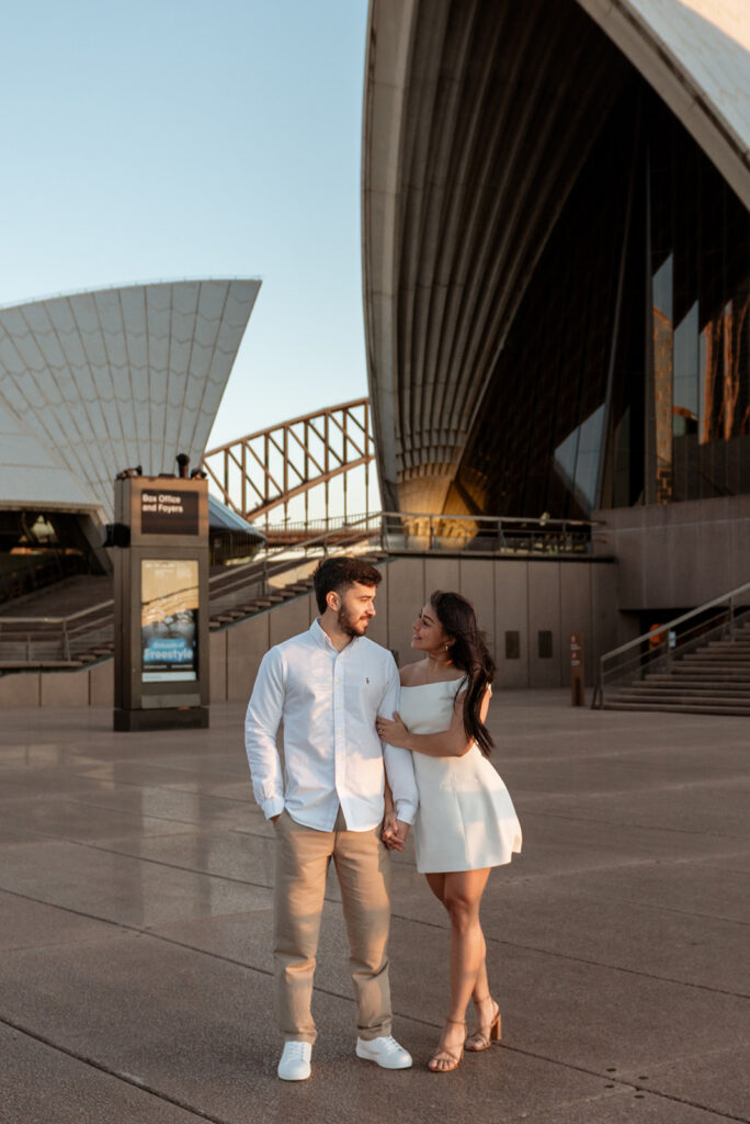 Couple in linen and natural fabrics walking together at golden hour, Sydney couples photographer Carolina Morgan